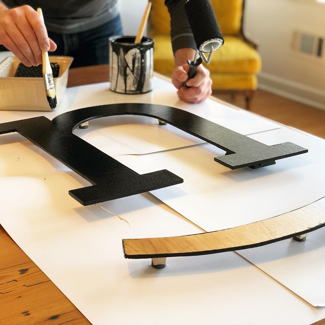 Painting our wooden logo black