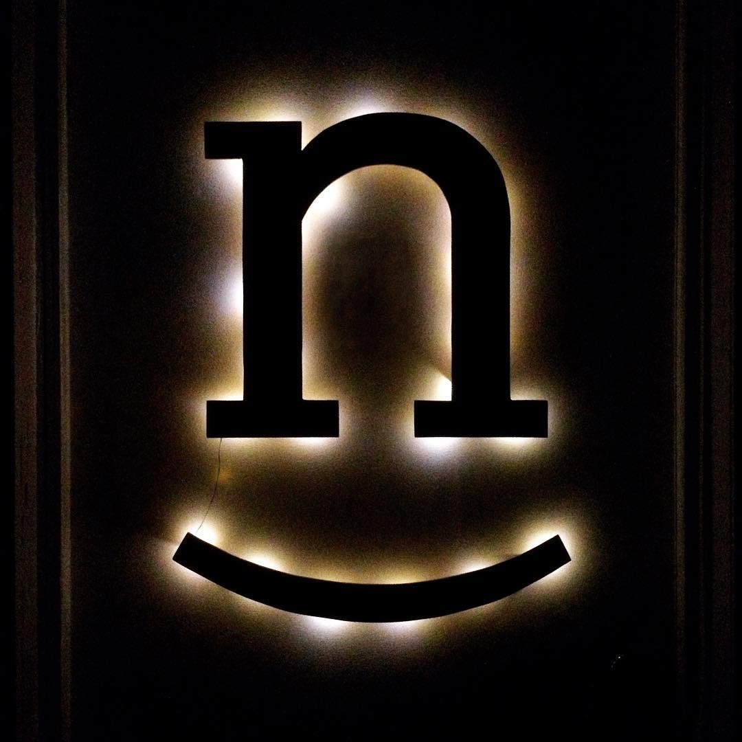Wooden logo illuminated in the dark.