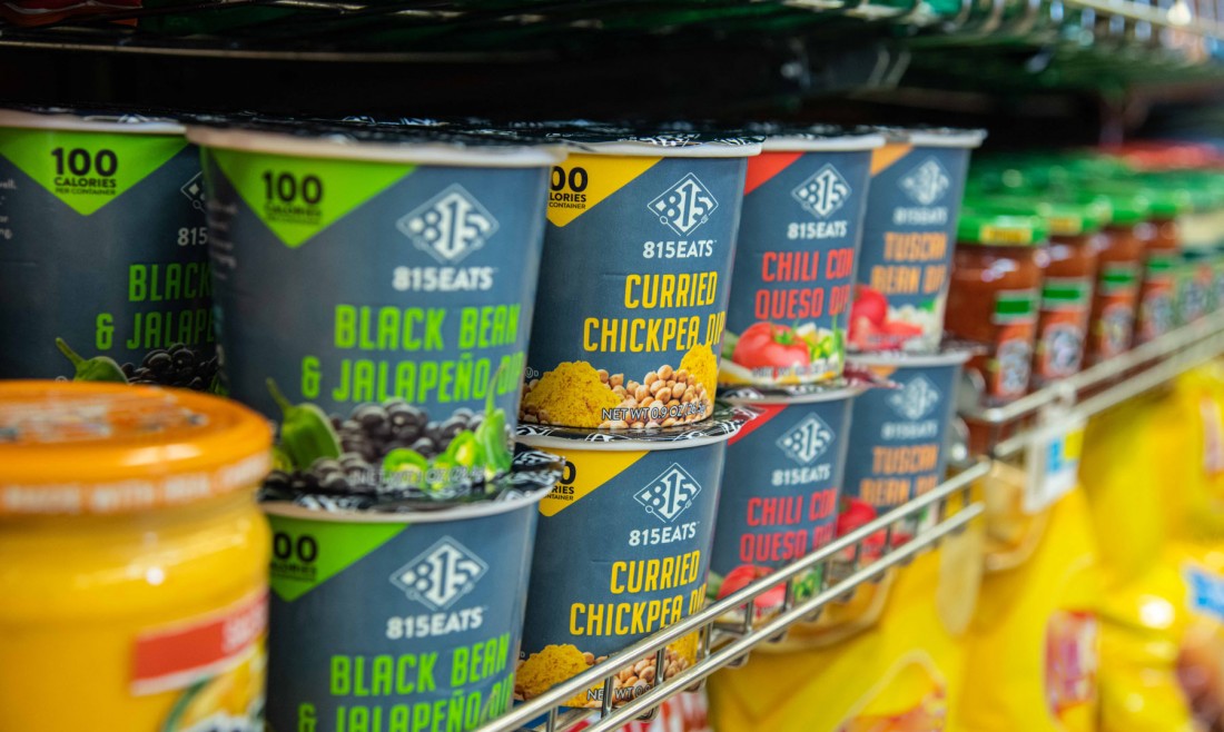 Photograph of 815Eats microwave dip cups on store shelf in the dips and chips aisle