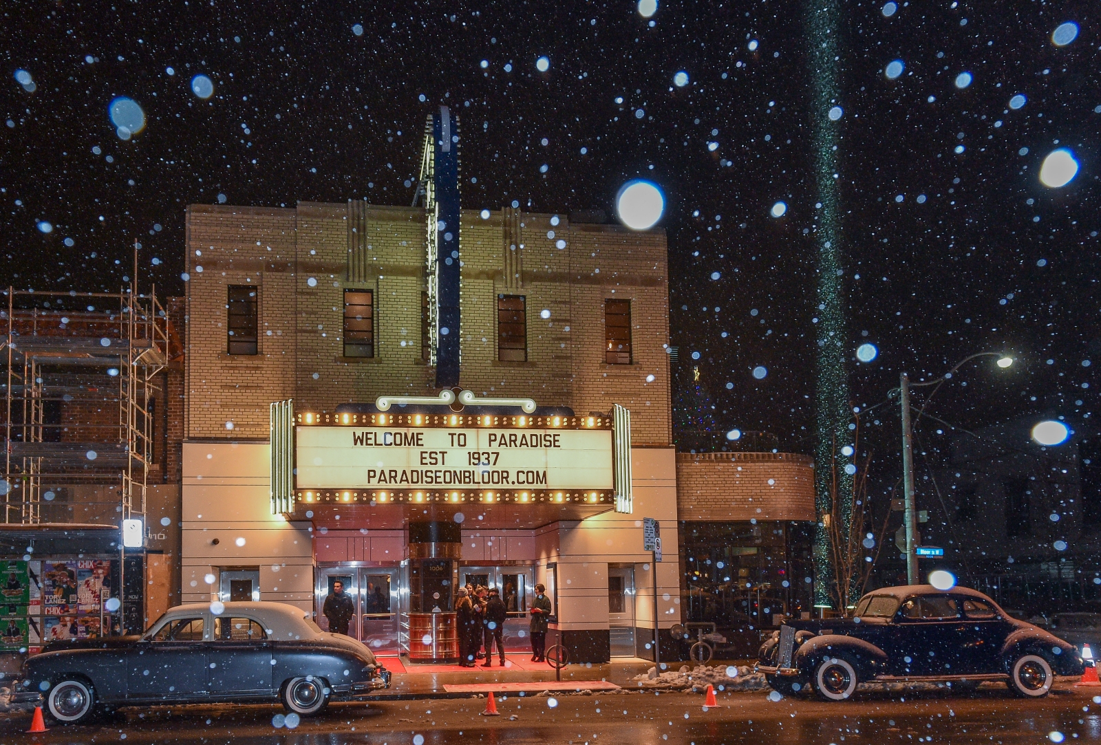 Paradise theatre exterior with vintage cars in front and the marquee reading "Welcome to Paradise est. 1937 paradiseonbloor.com"