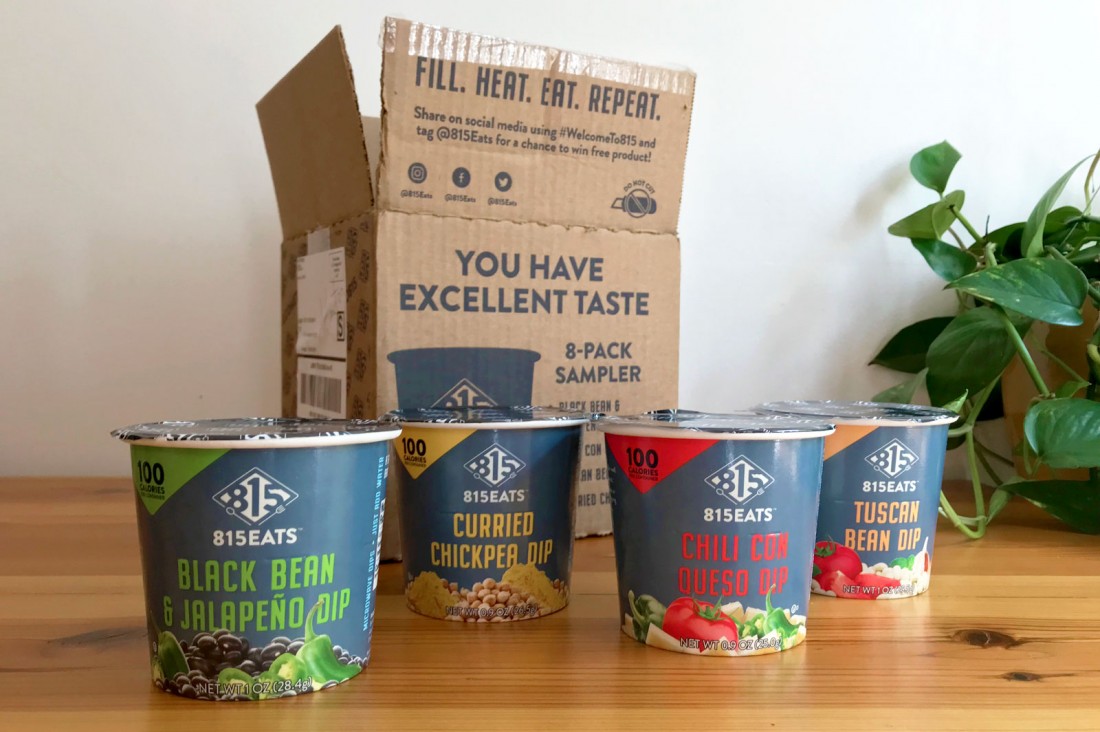 A delivered 815Eats box that says "You have excellent taste" along with all four dip flavors sitting on a table in front of the box.